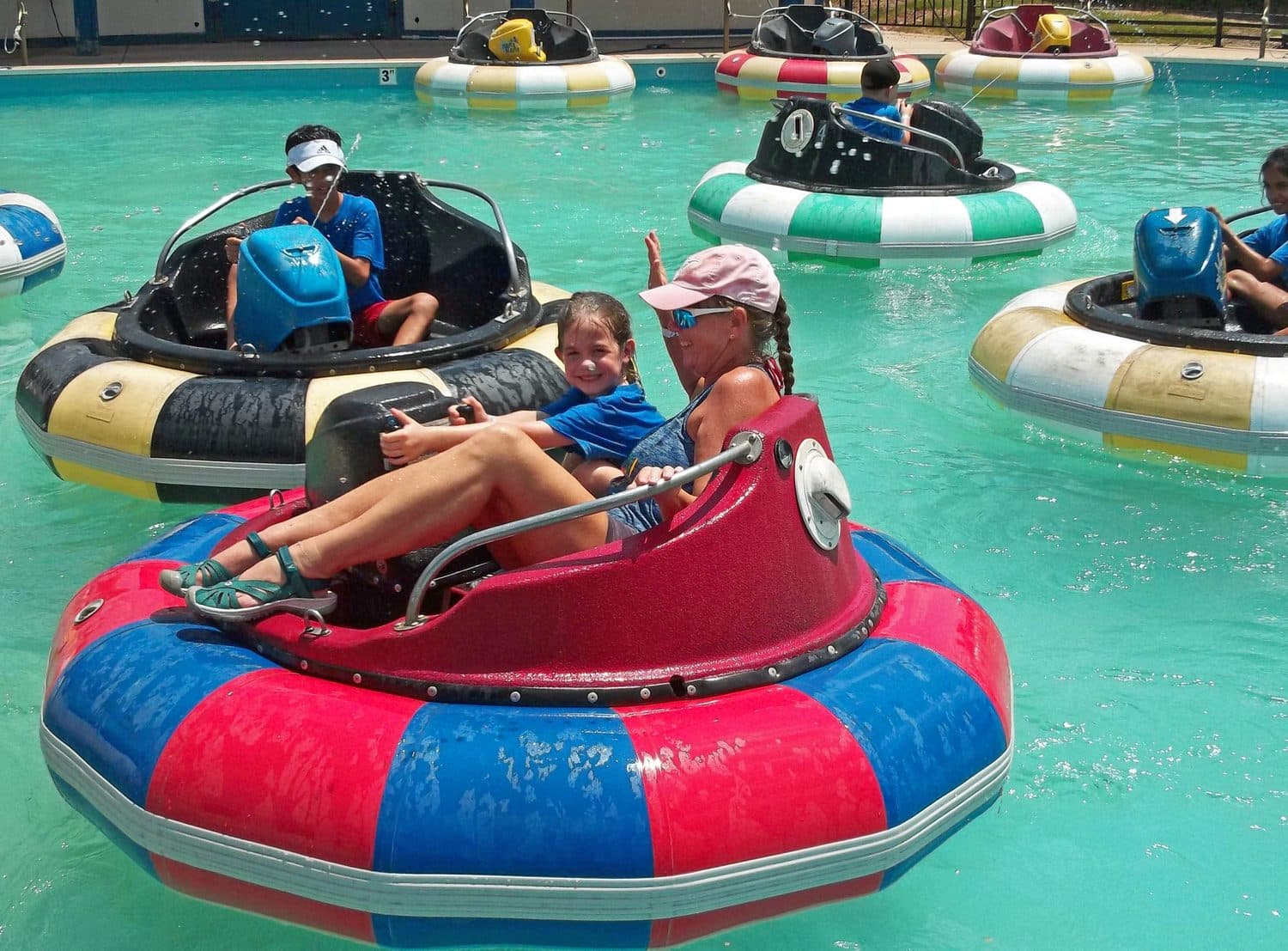 Crystal Challenges campers riding bumper boats together on a summer field trip.